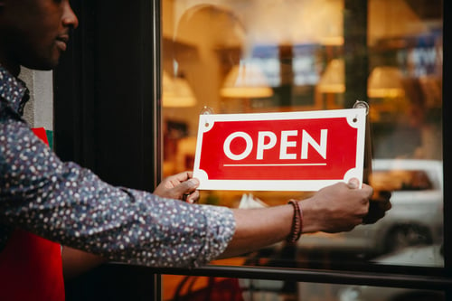 putting an open sign up on storefront | legacy law firm, sioux falls estate planning lawyers