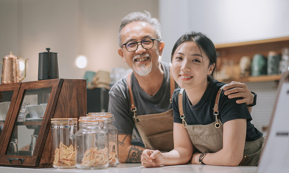 employees smiling behind a store counter