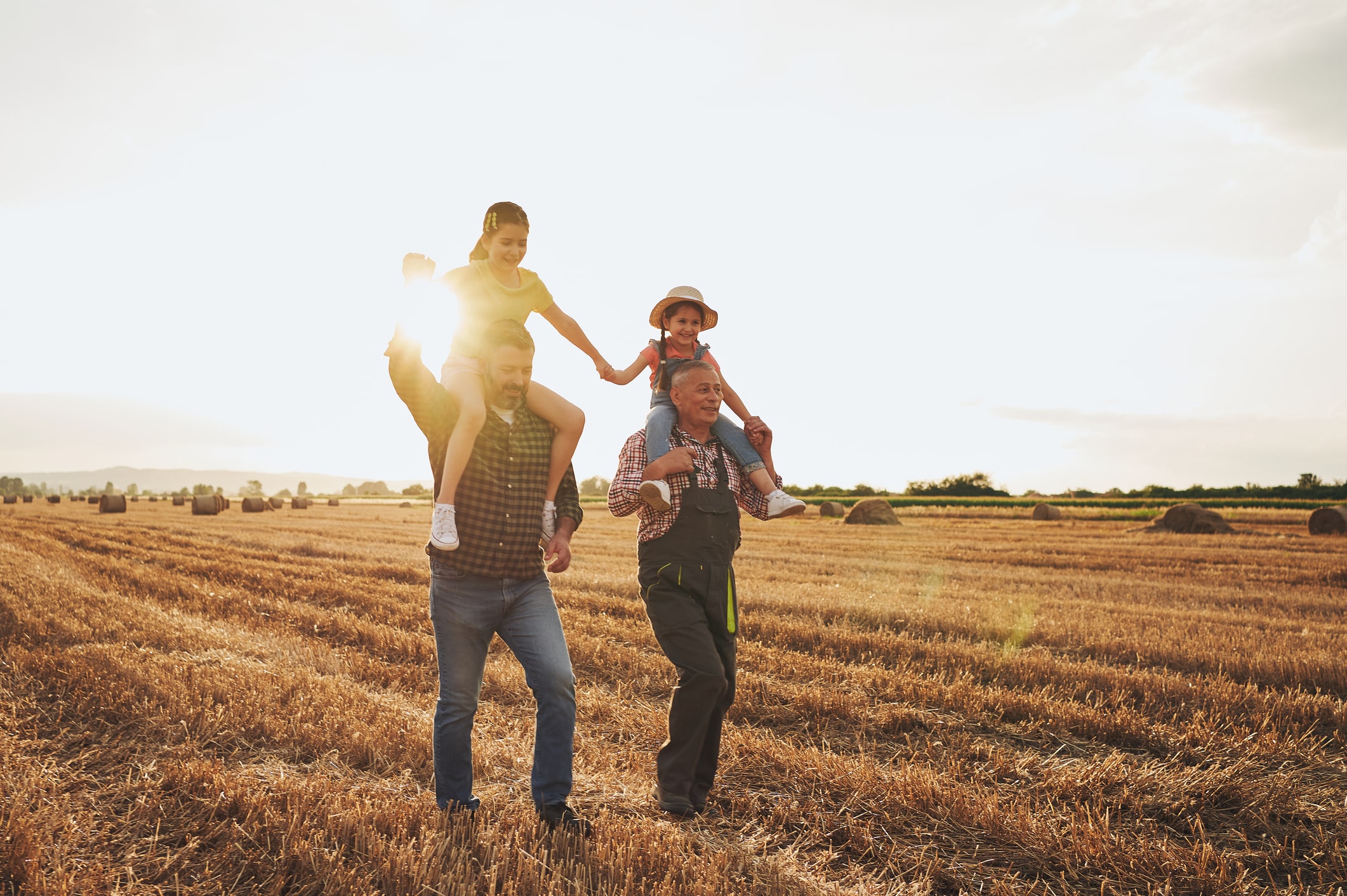 family walking through a hay field