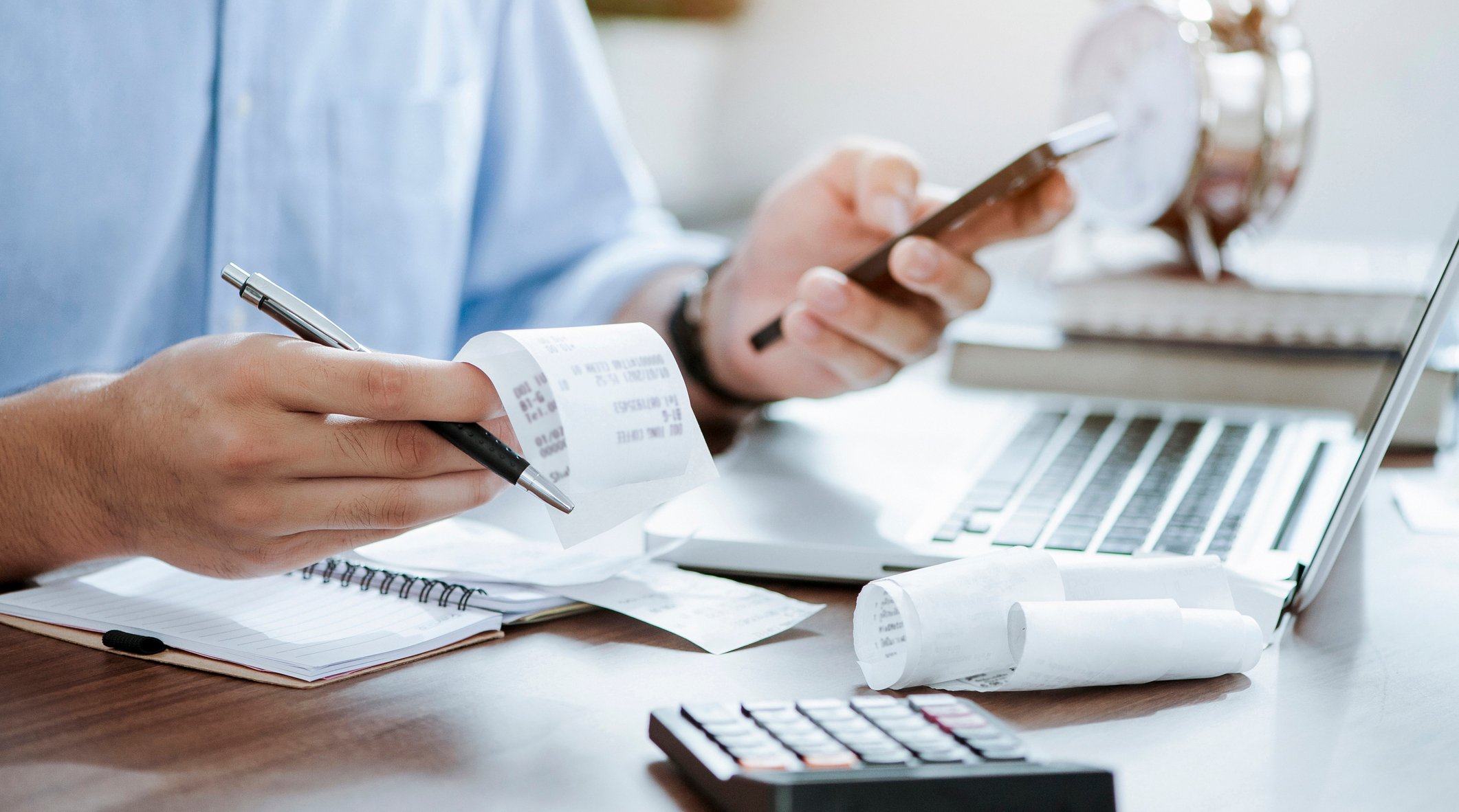 business planning - person calculating receipts doing taxes