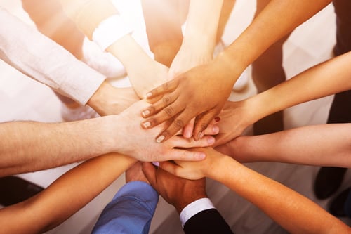 group of hands together in a huddle