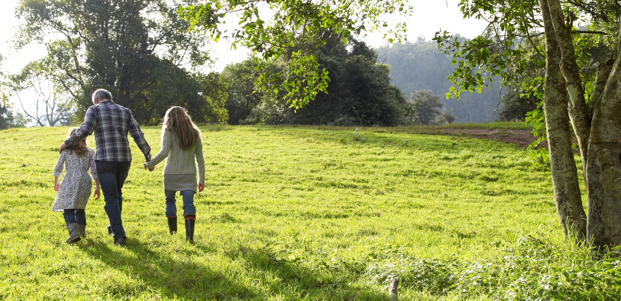 family walking through a grassy area