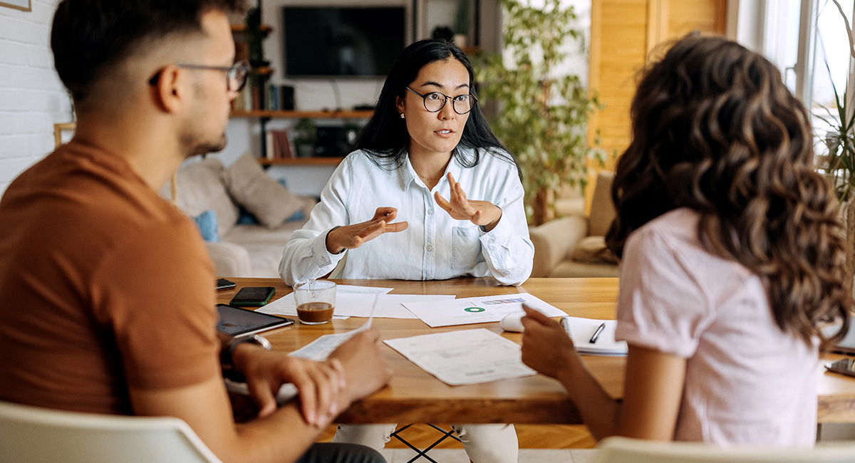 women explaining paperwork