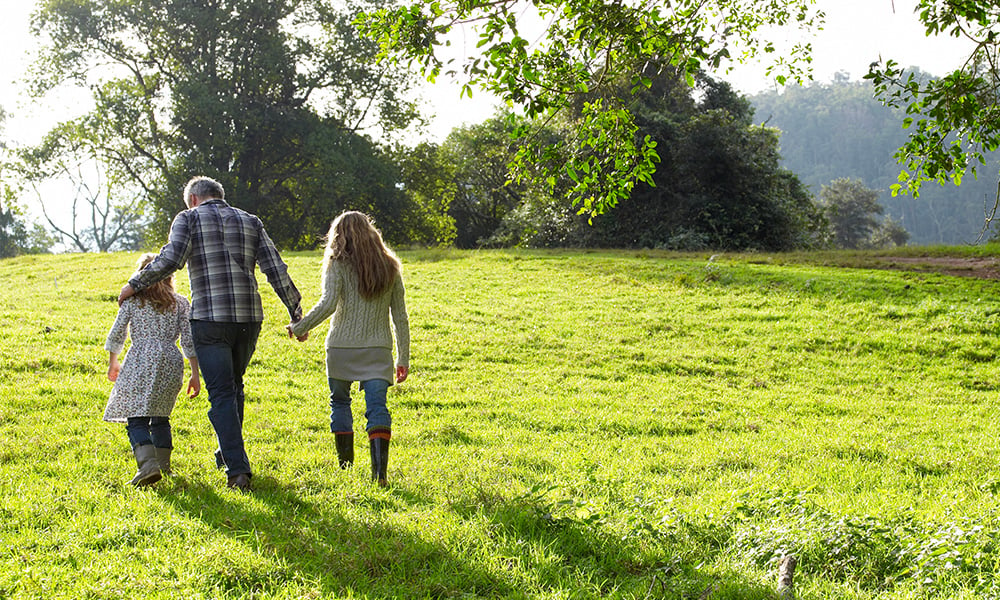 family walking through a grassy area