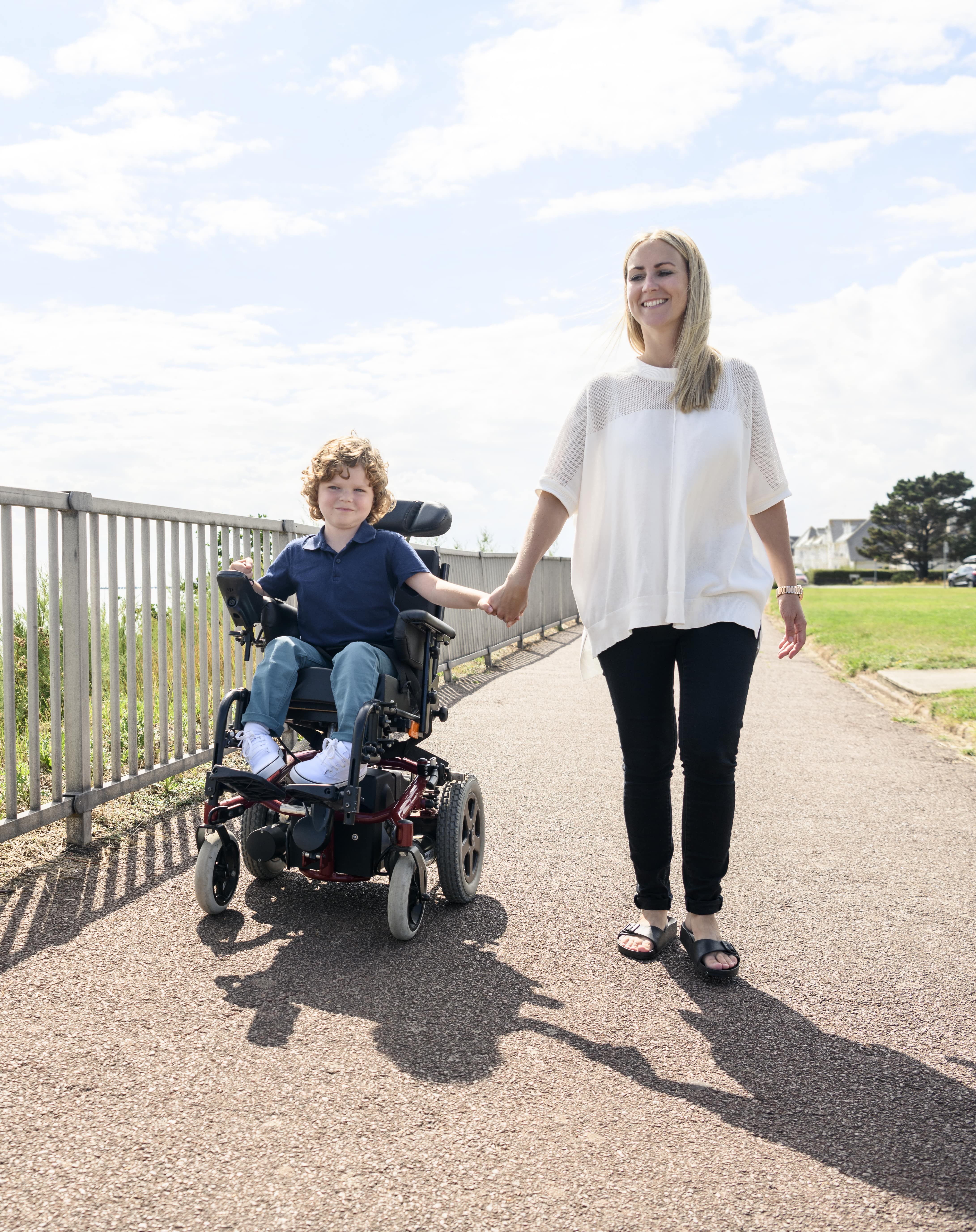 mom and son on a sidewalk