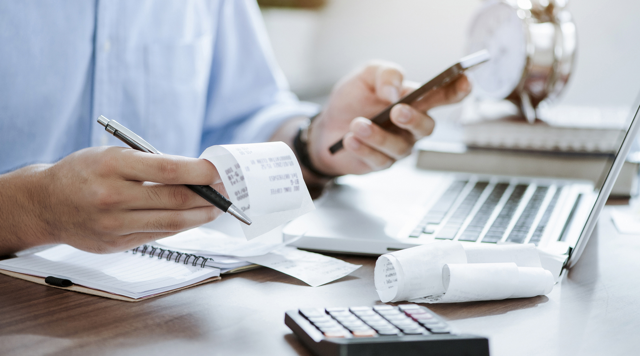 person calculating receipts person calculating receipts