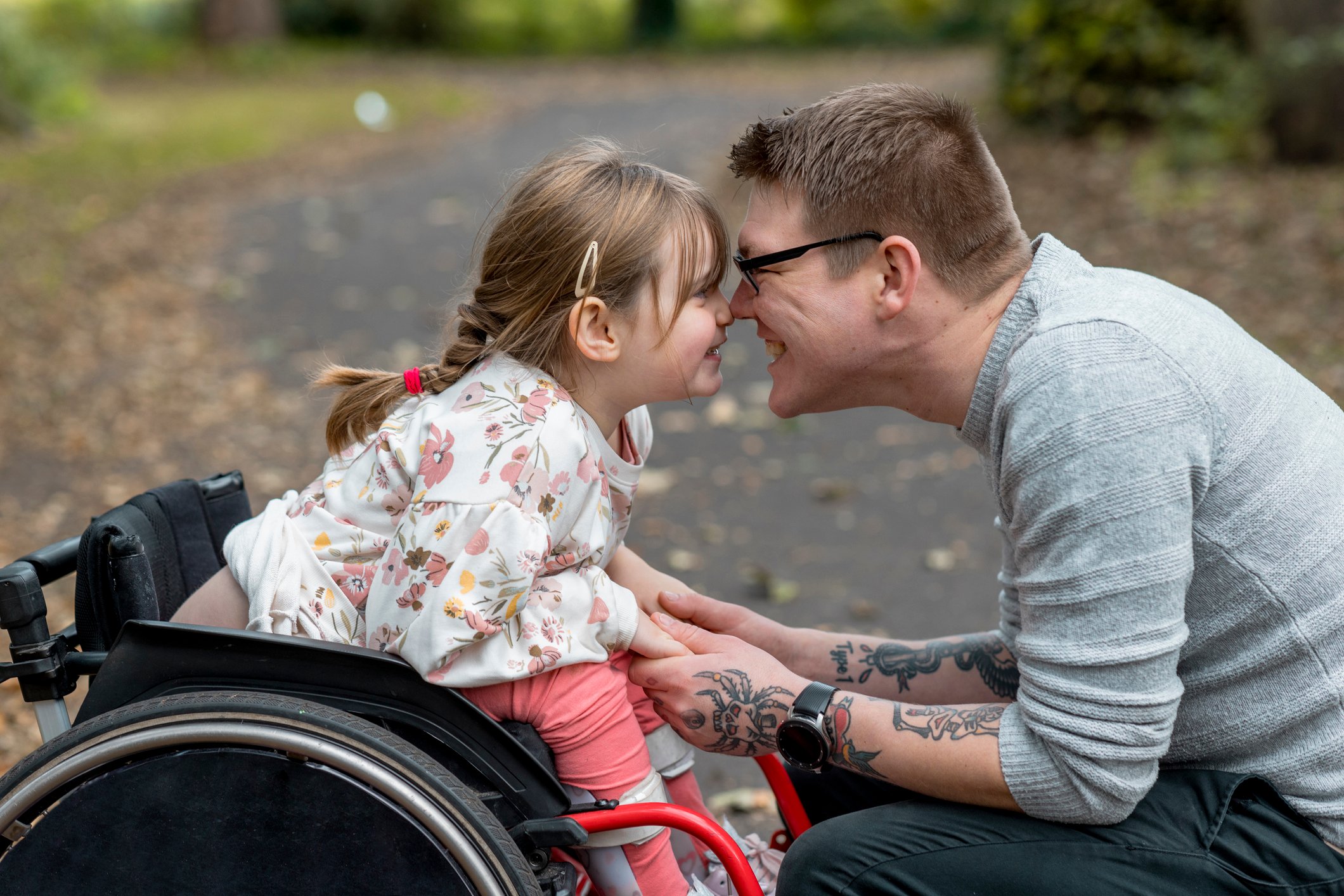 girl in a wheelchair with her dad